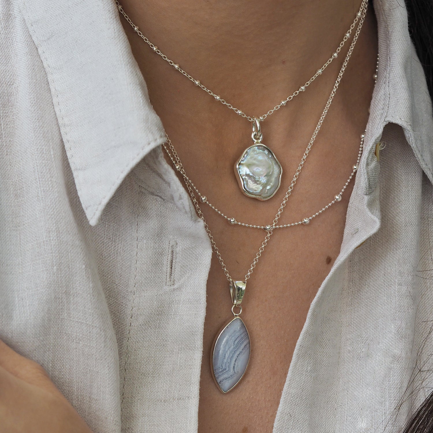 Layered blue lace agate gemstone pendant with a baroque pearl pendant and sterling silver chains