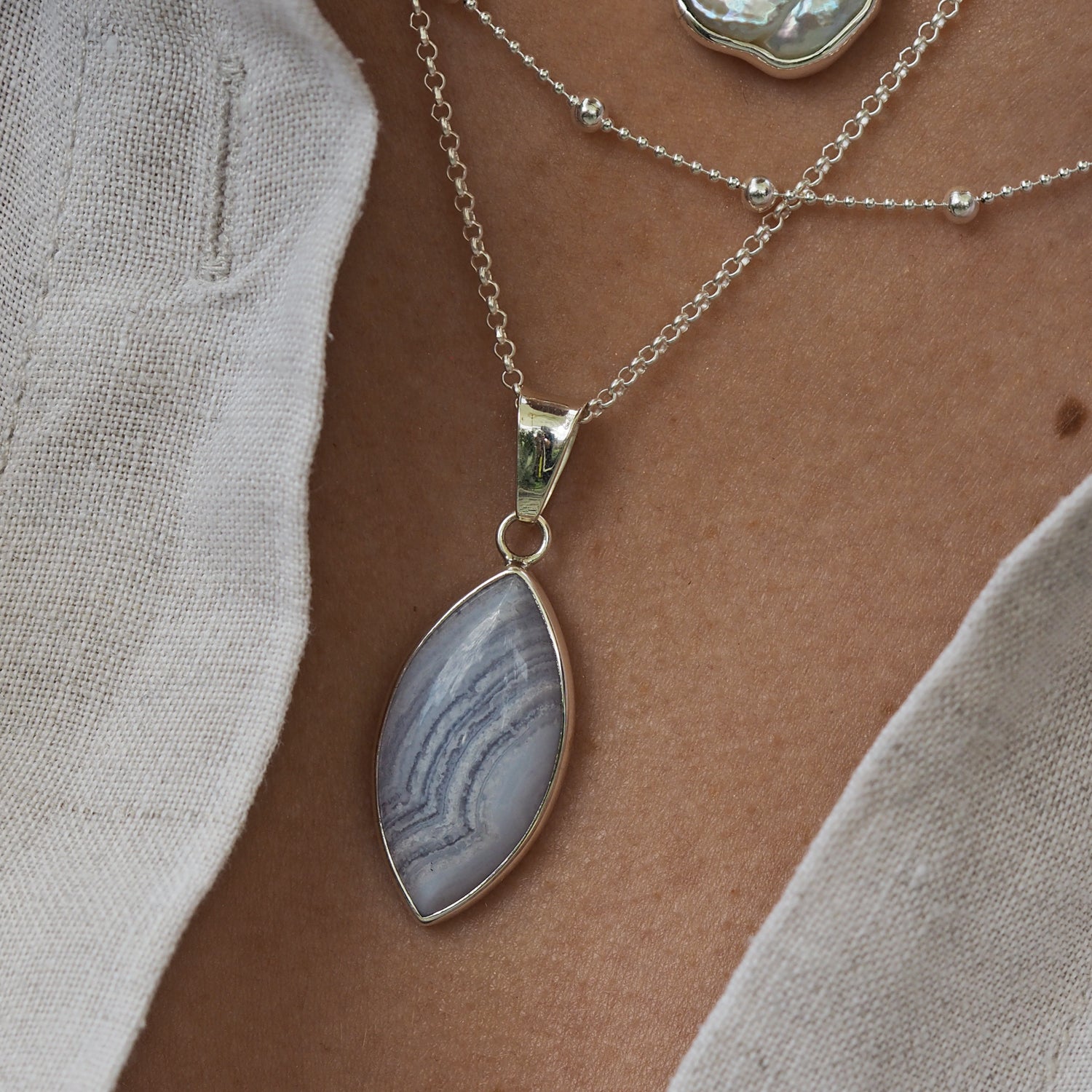 Contemporary blue lace agate pendant layered with sterling silver chains