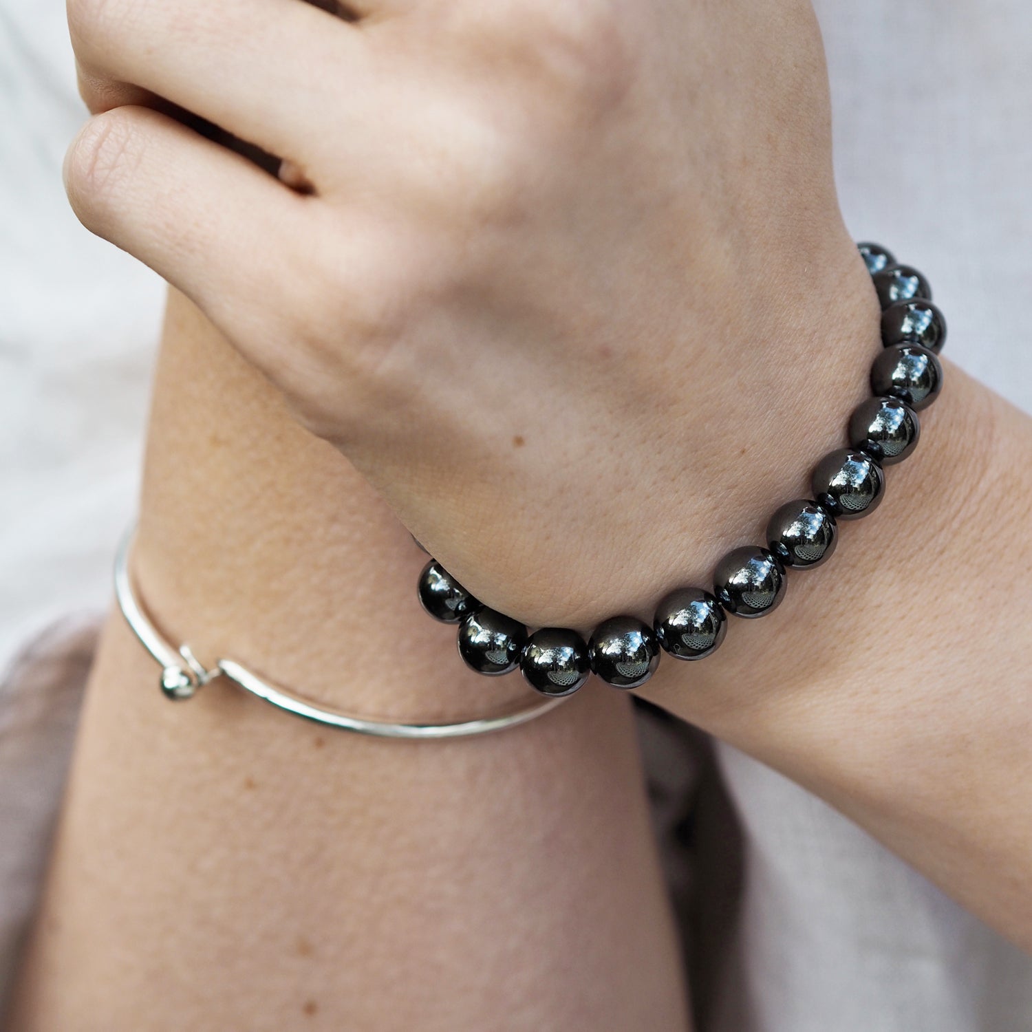 Contemporary hematite beaded bracelet worn on a wrist, designed in UK