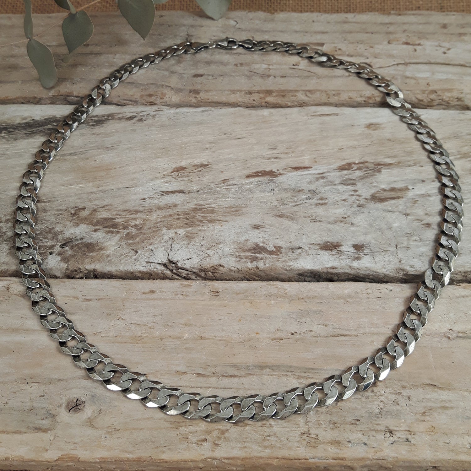 Oxidised sterling silver chain unisex necklace on a wooden surface