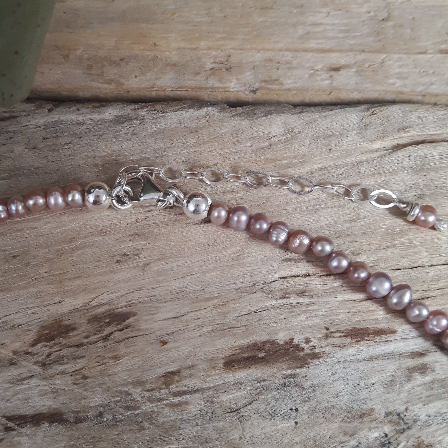 Close-up of a pearl necklace on a wooden surface