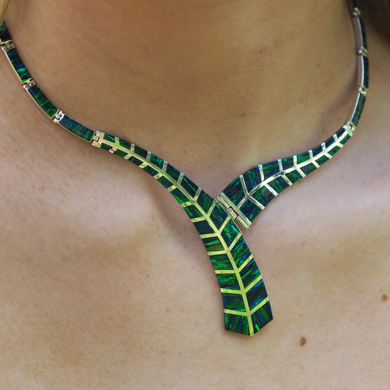 Rio cultured opal necklace with emerald detail design on a person's neck