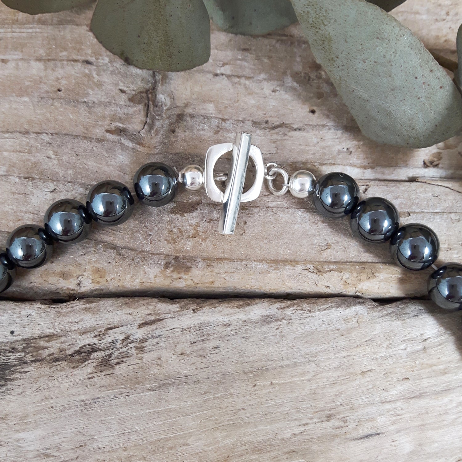 UK-designed close-up sterling silver t-bar fastening on a hematite beaded necklace
