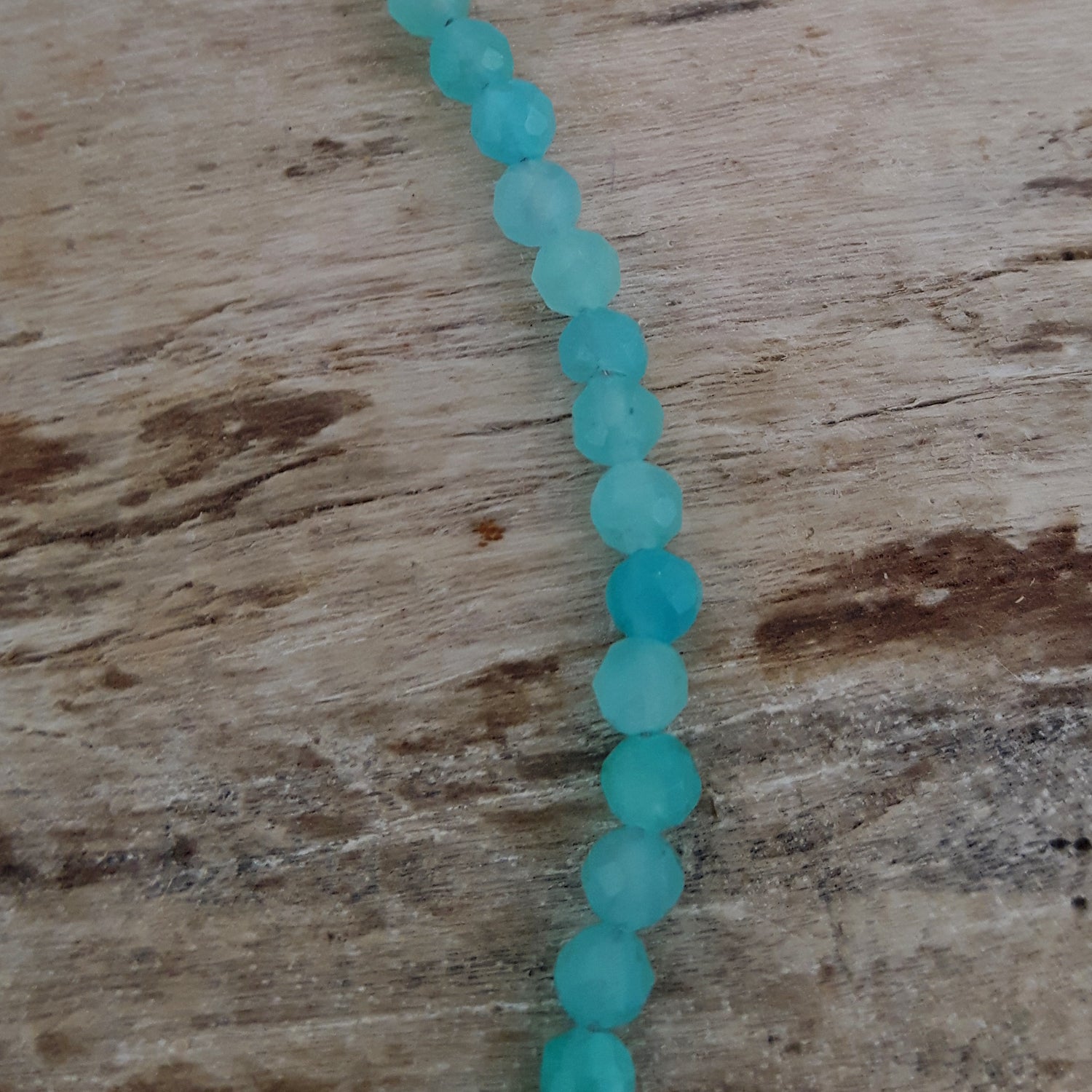 Amazonite bead bracelet on a wooden surface