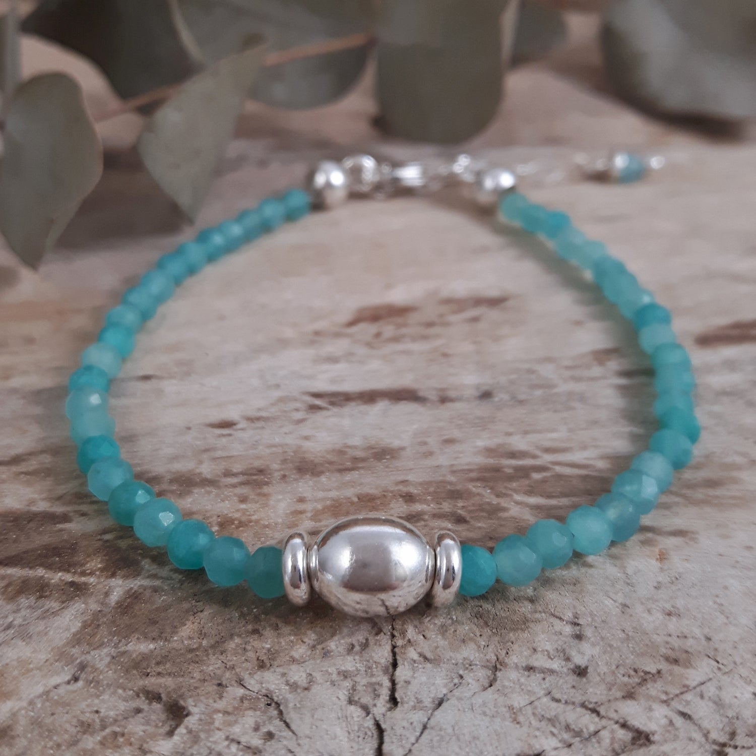 Amazonite beaded bracelet with sterling silver beads on a wooden surface