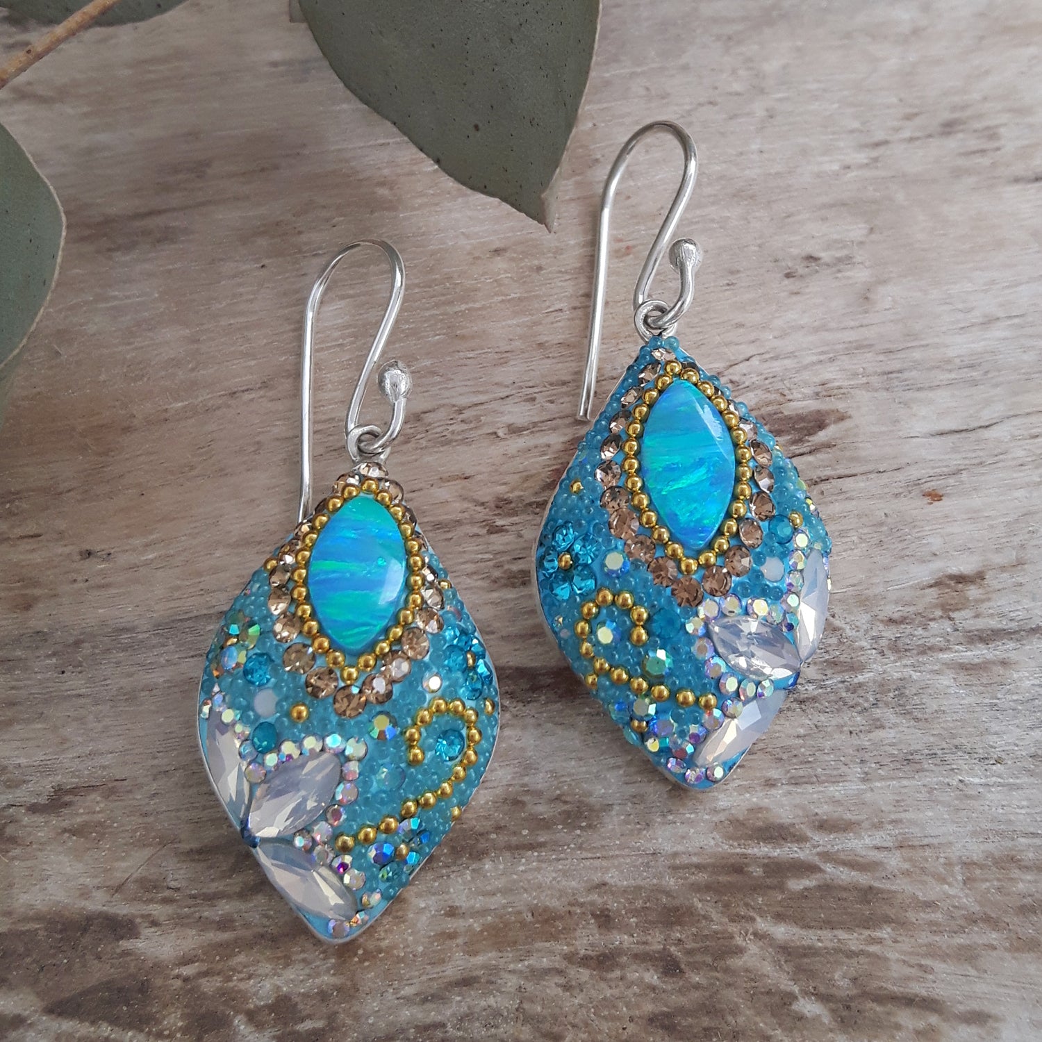 close up opal drop earrings crystal detail from above