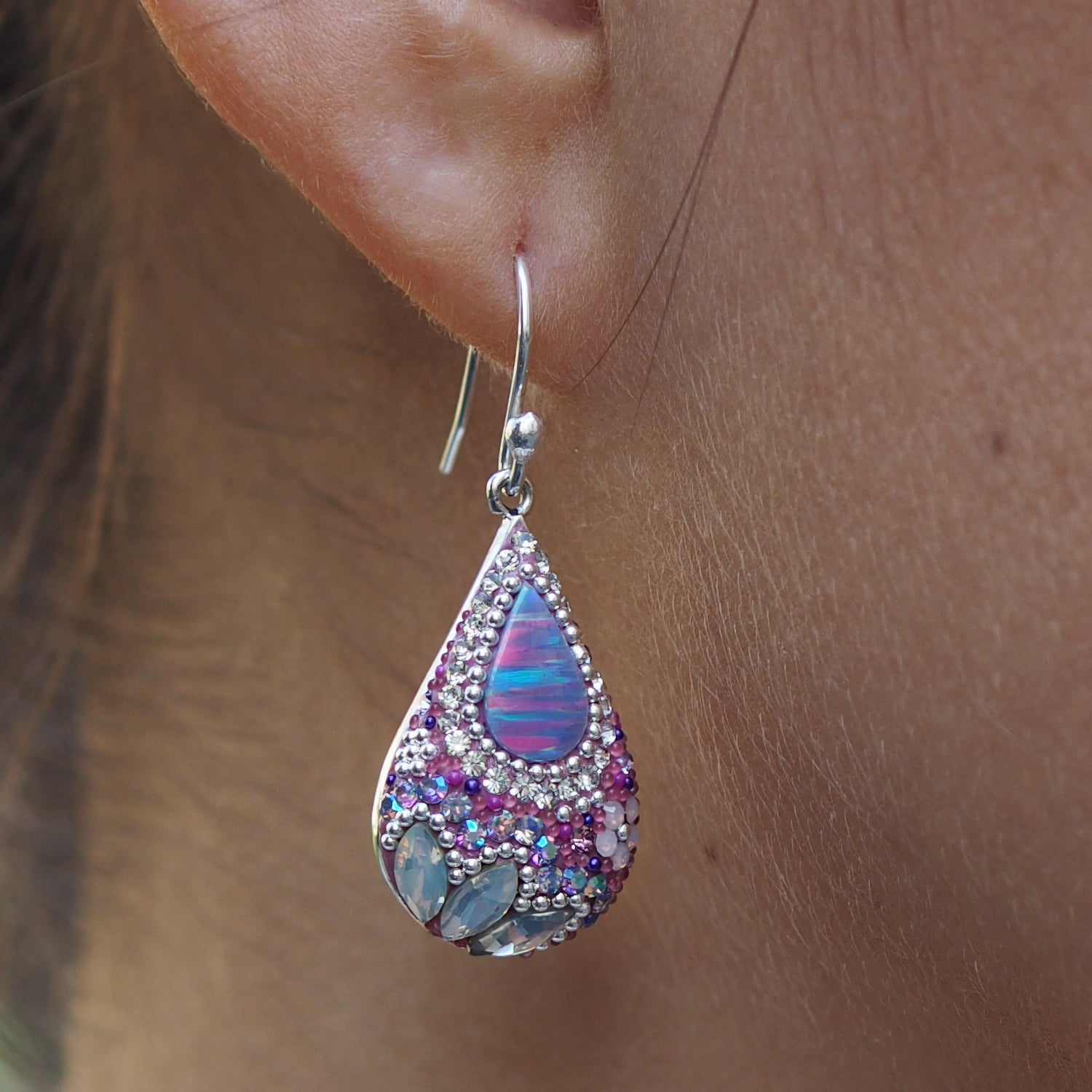 close up lilac earrings opal centre detail worn in ear