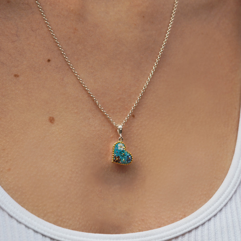 Lucy wears the daisy turquoise heart pendant on a rolo chain
