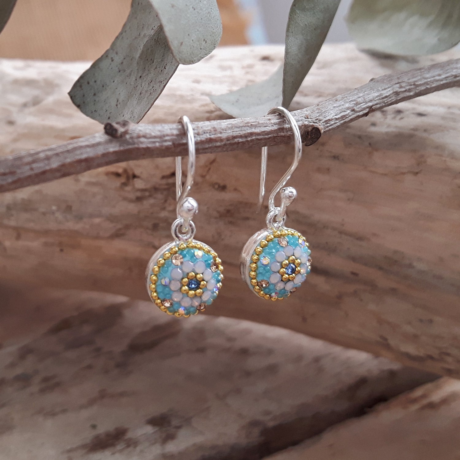 close up turquoise daisy drop earrings micro bead and crystal detail