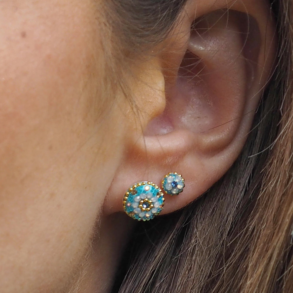 different sized lightweight small turquoise stud earrings worn on ear