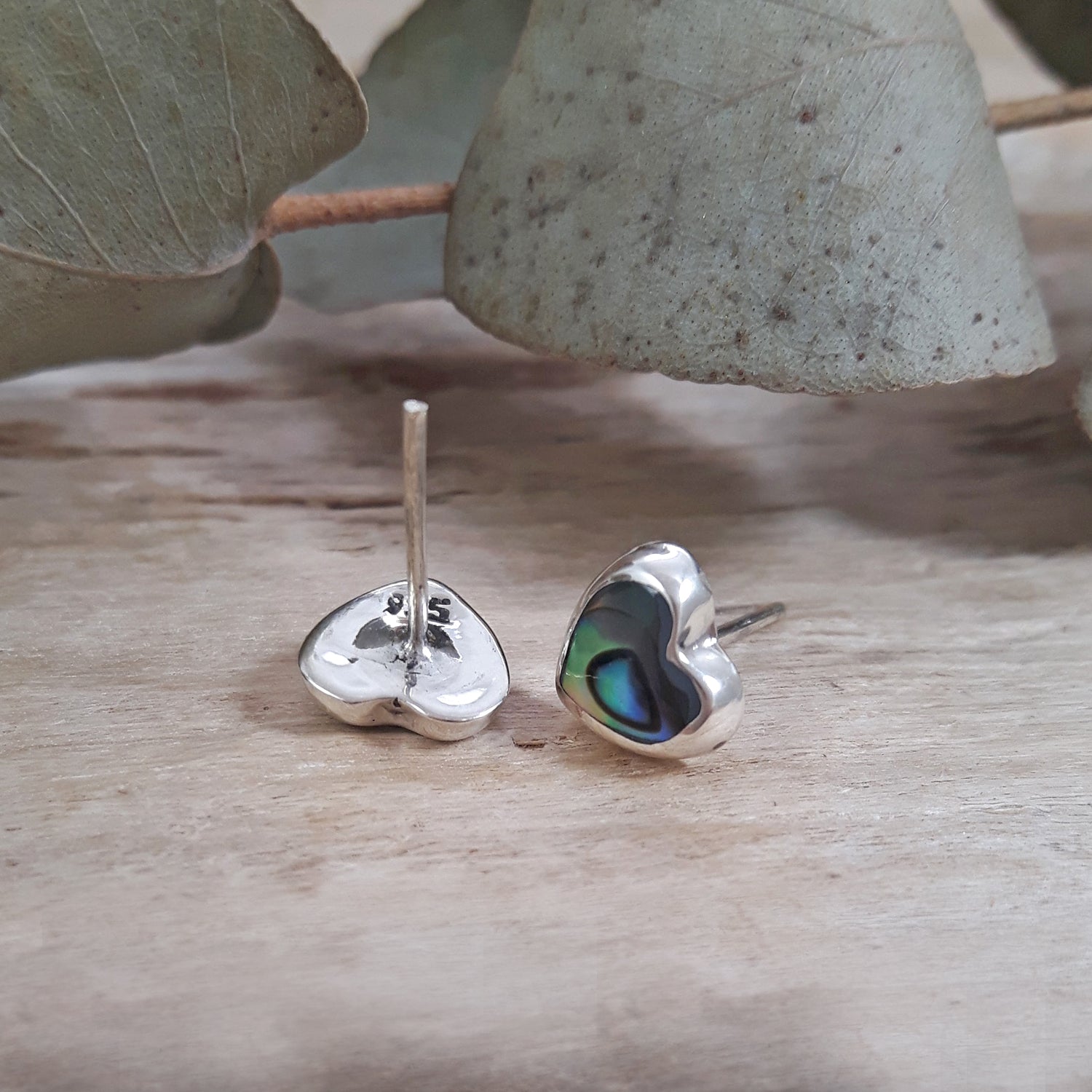 Back of 925 sterling silver abalone heart stud earrings showing hallmark stamp and stud post.
