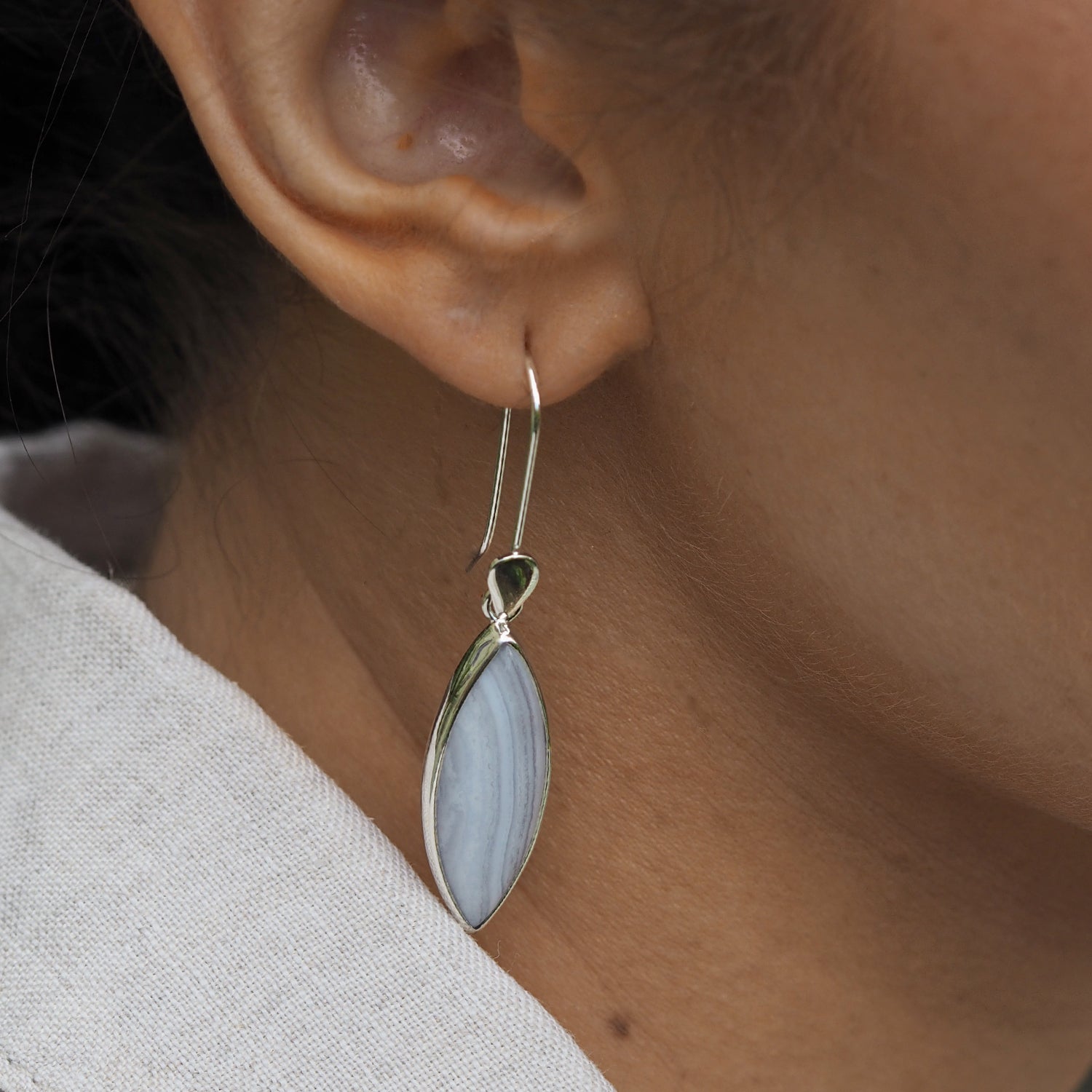 Unique blue lace agate stone hand-set in sterling silver worn in ear UK