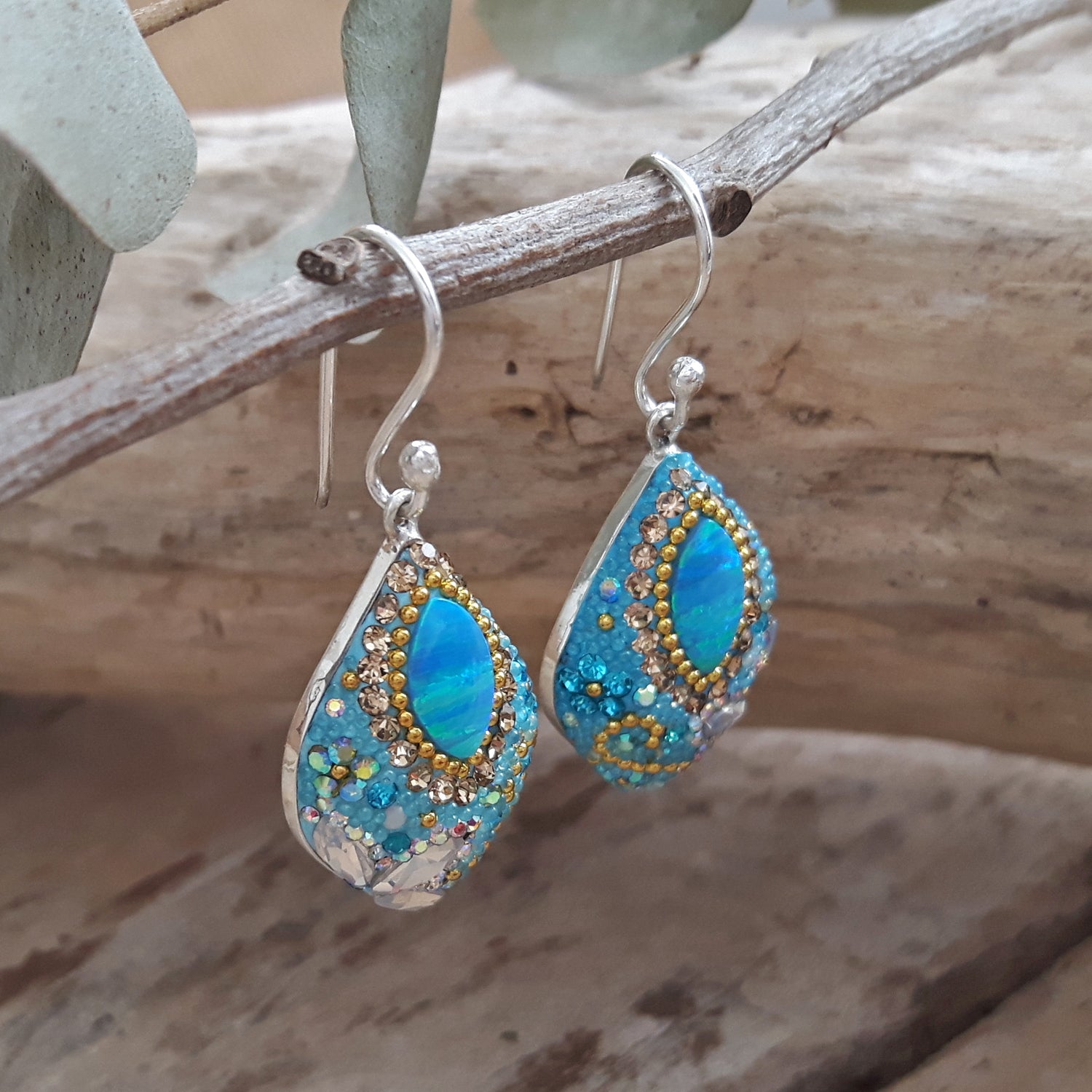close up opal drop earrings crystal detail