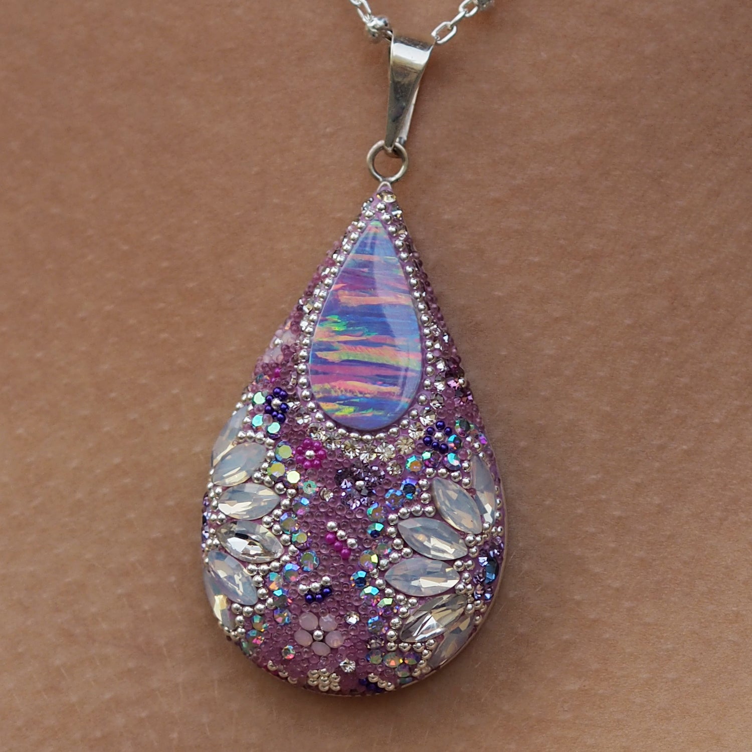 close up lilac pendant opal centre crystal detail