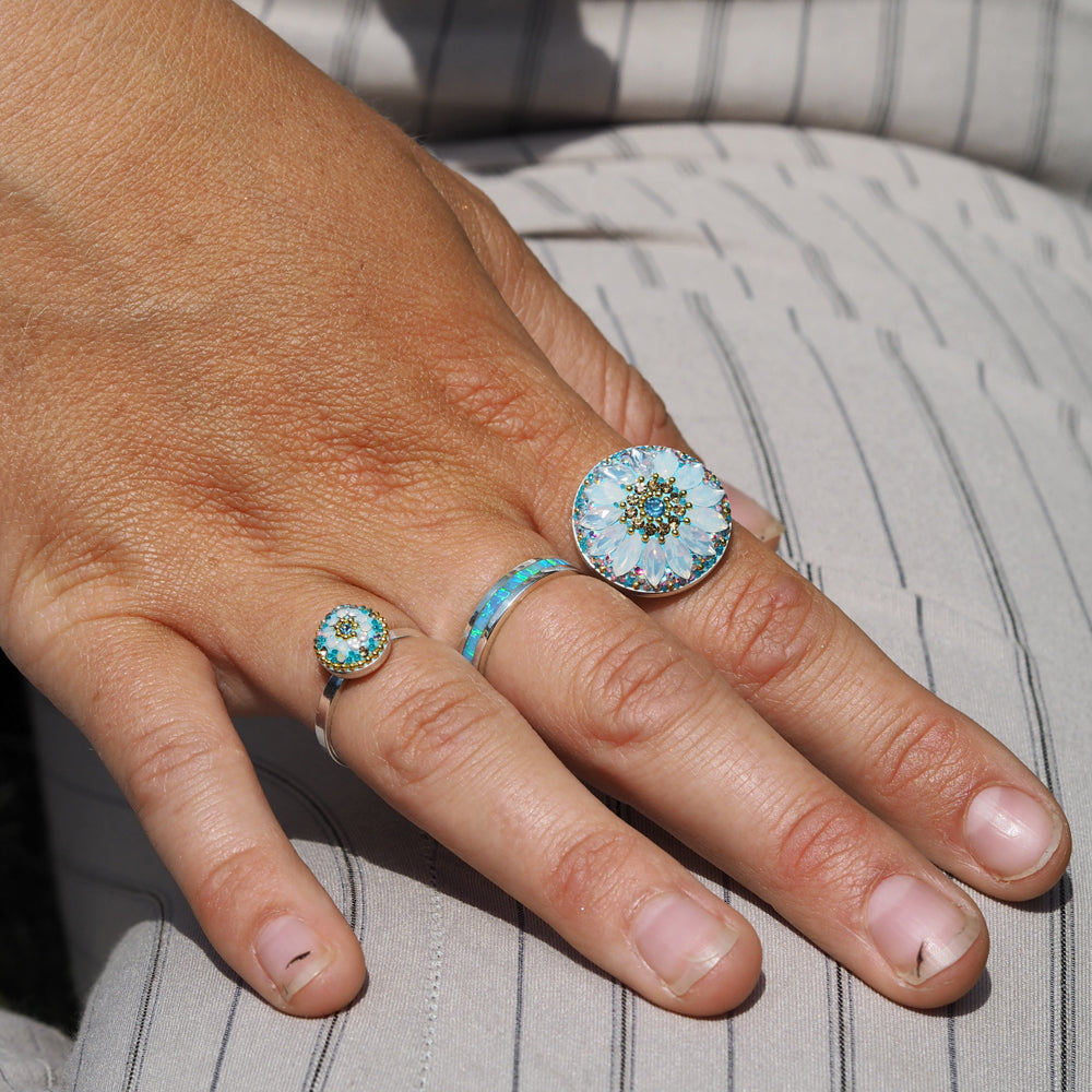 turquoise daisy disc ring worn on hand statement with other rings