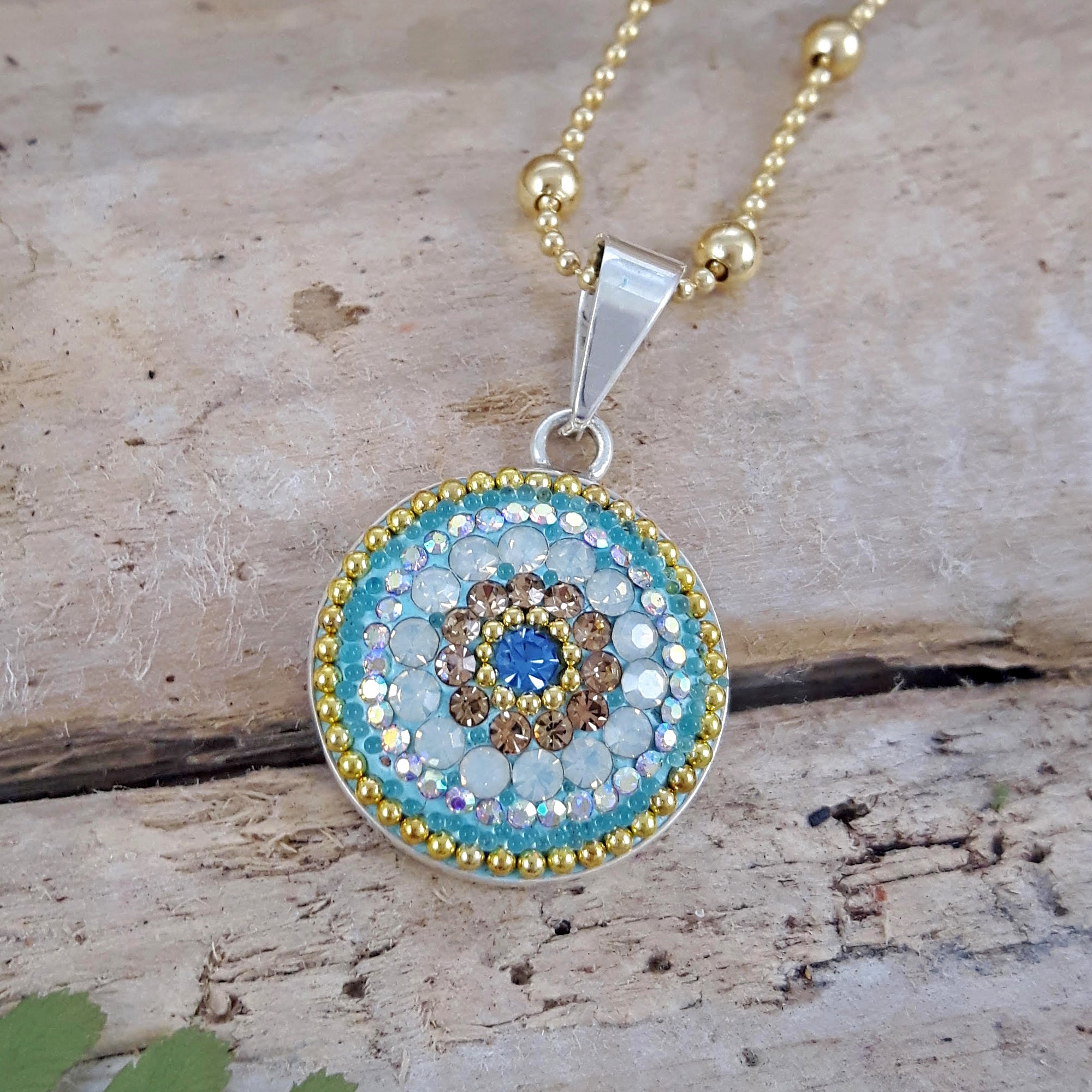 close up daisy coin pendant crystal detail